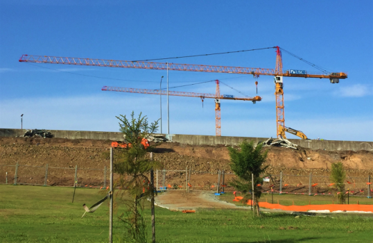 The USC banner blows above the Petrie campus construction site, in the heart of Dickson.