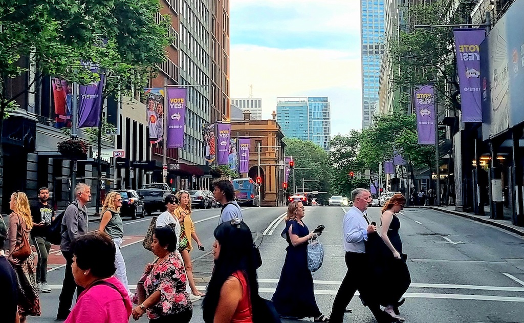 A group of people walking on a city street