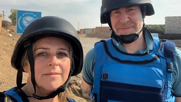 A person wearing a helmet posing for the camera