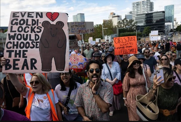 A group of people holding a sign