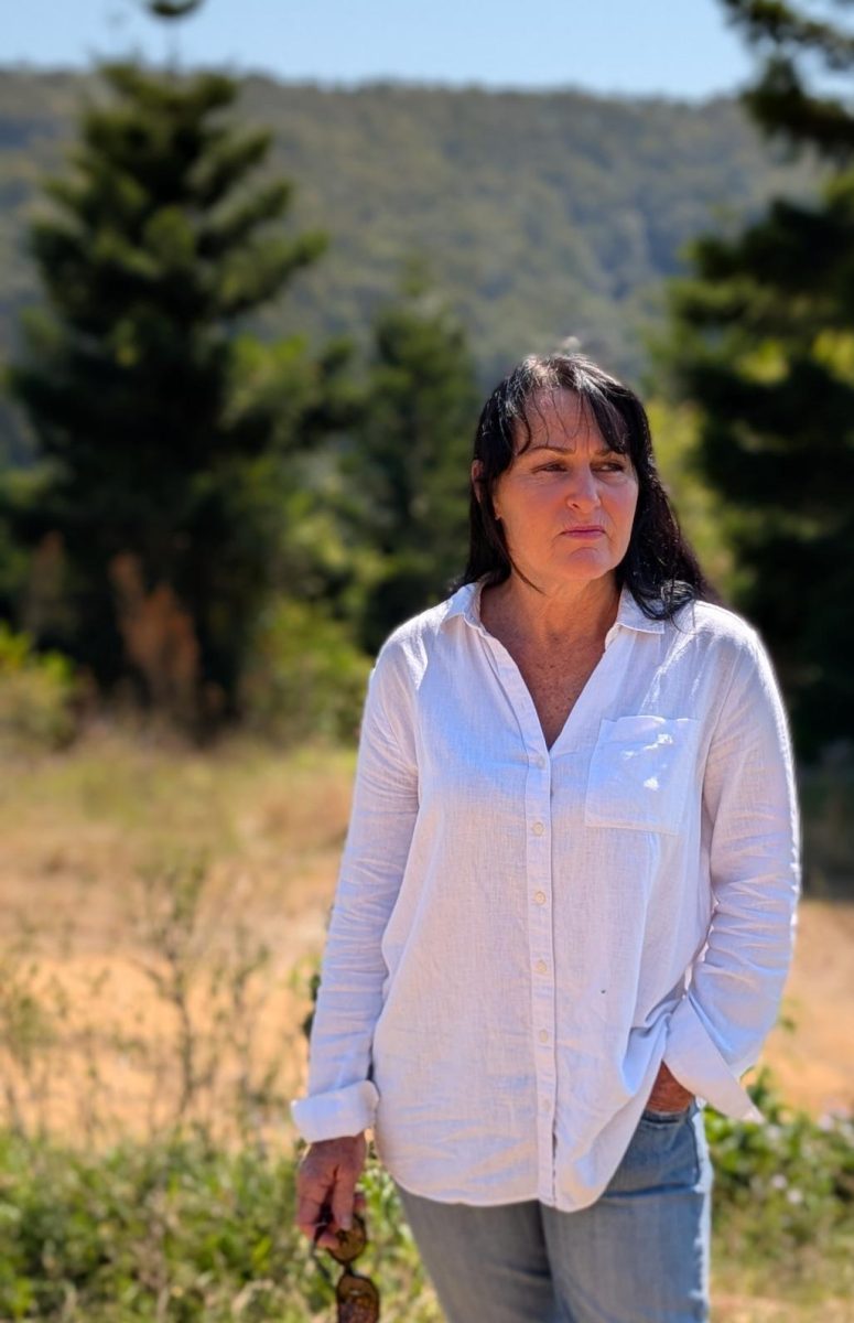 A person standing on top of a grass covered field