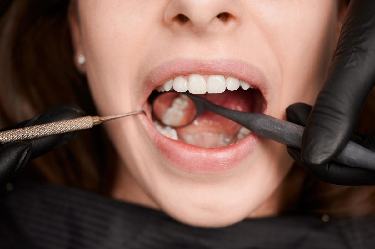 A close up of a woman brushing her teeth