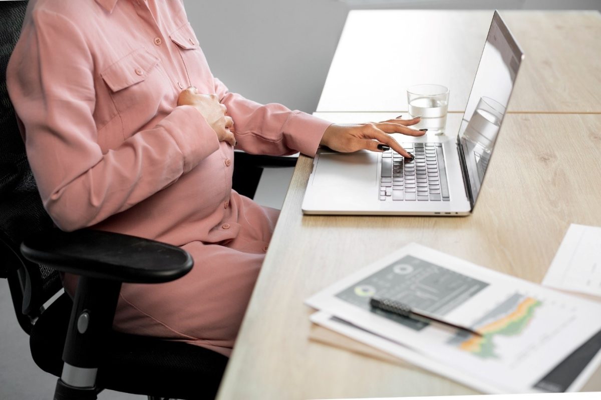 A person sitting at a table using a laptop