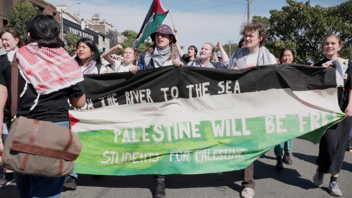 A group of people holding a sign