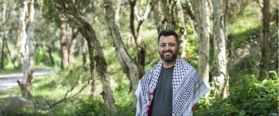 A man standing next to a tree