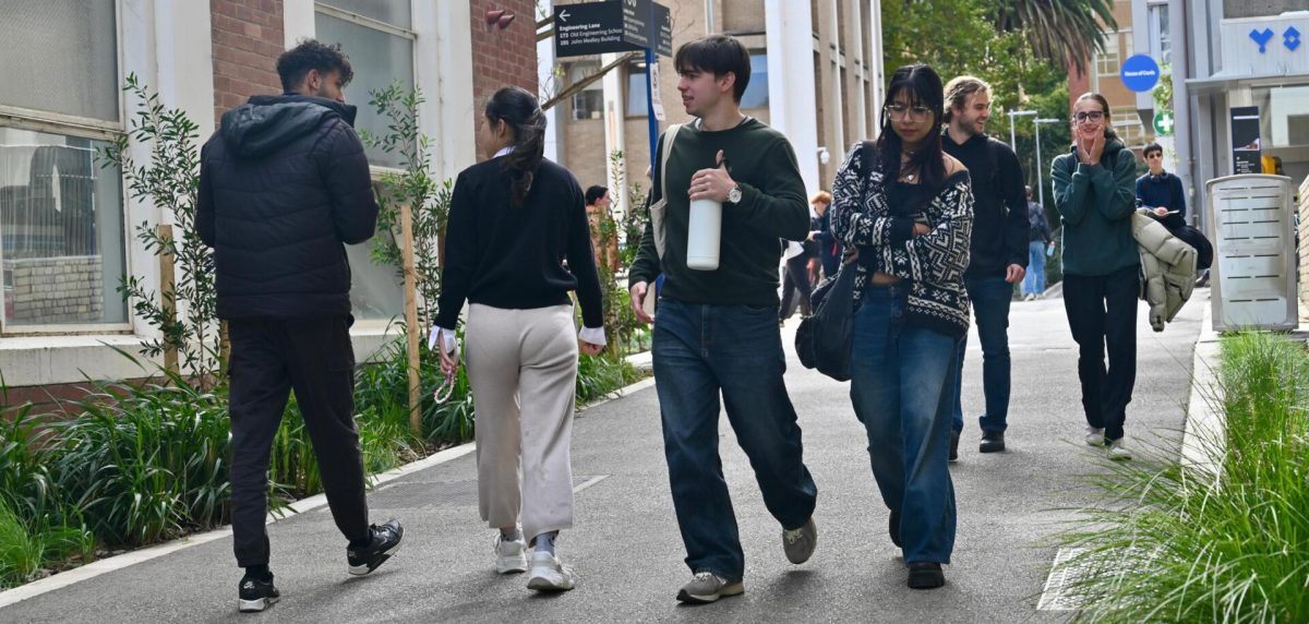 A group of people standing on a sidewalk