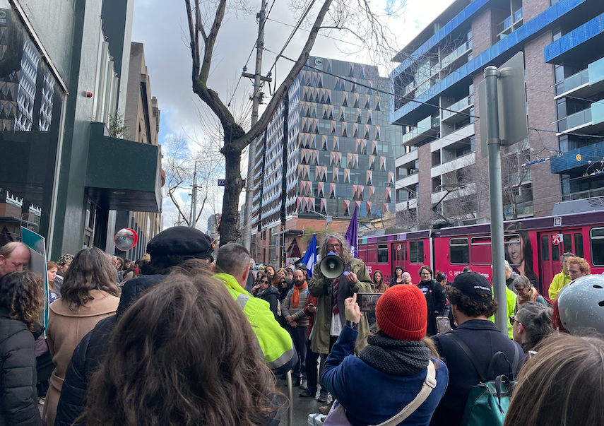 A group of people walking on a city street